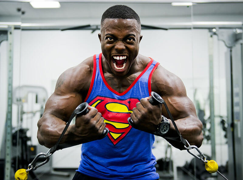 Man in superhero shirt lifting weights