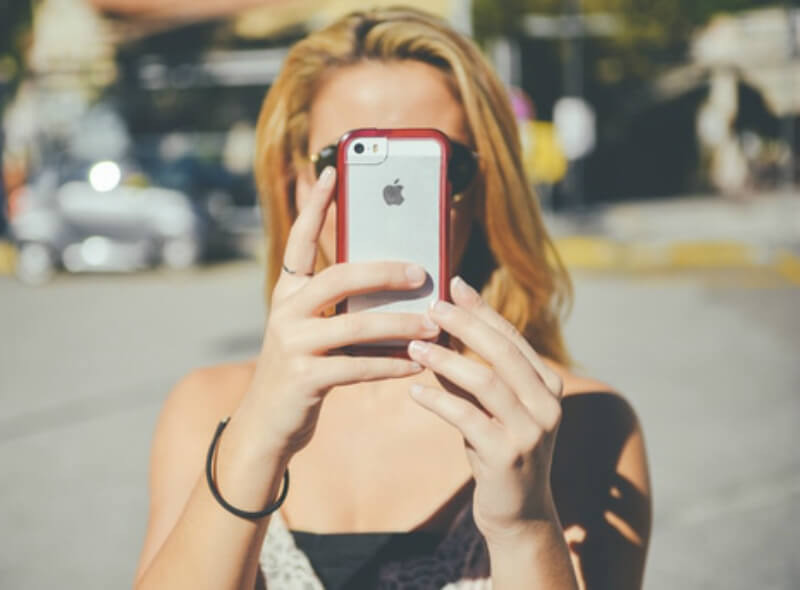 Girl taking selfie with an iPhone 