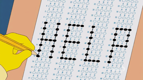 hand fills in circles on a scantron sheet in the shape of the word 'help'