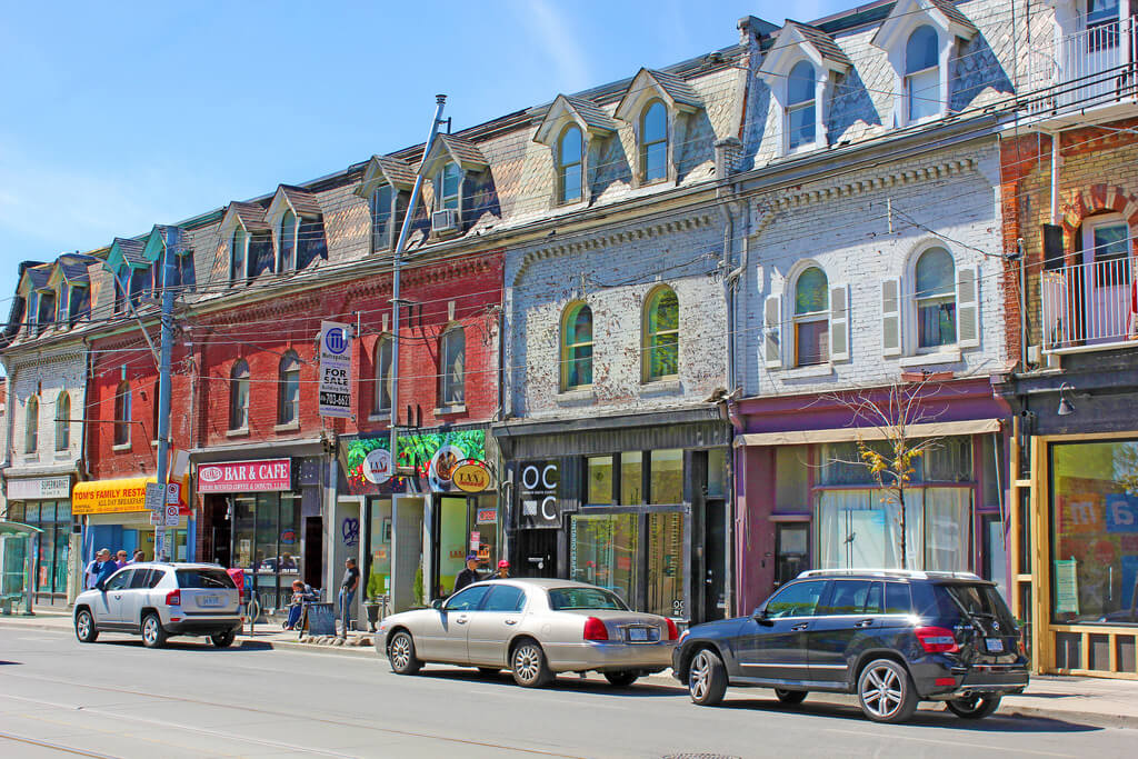 a view of storefronts along queen street west
