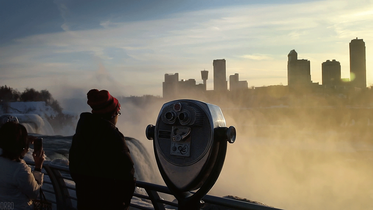 a person looking at the mist of Niagara Falls