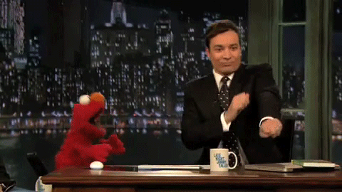 TV host, Jimmy Fallon, and Muppet character, Elmo, doing a dance 