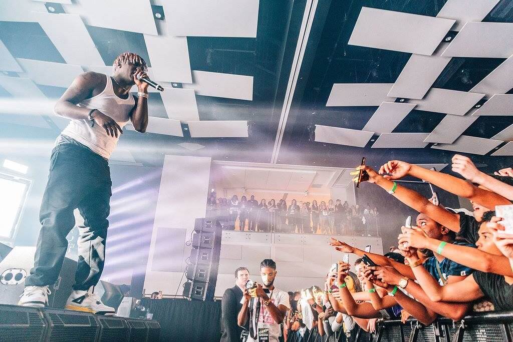 Lil Yachty standing on stage in front of crowd