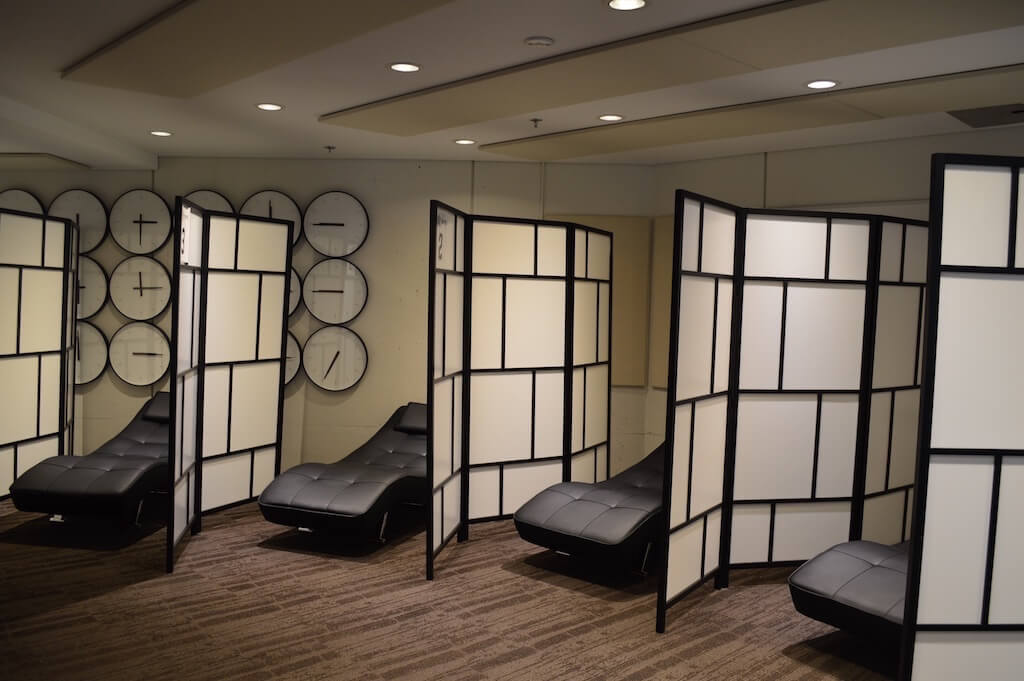 A row of beds separated by dividers in the IGNITE Sleep Lounge.