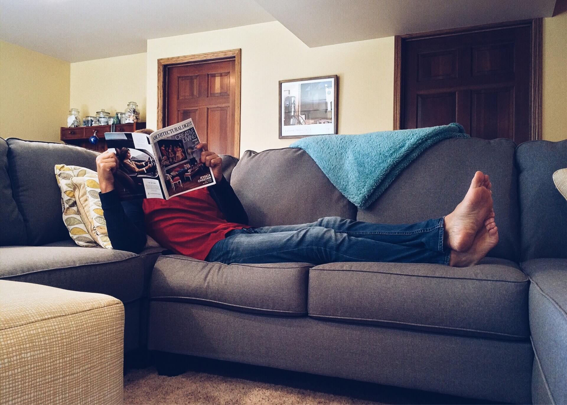 Guy sitting and reading on a couch