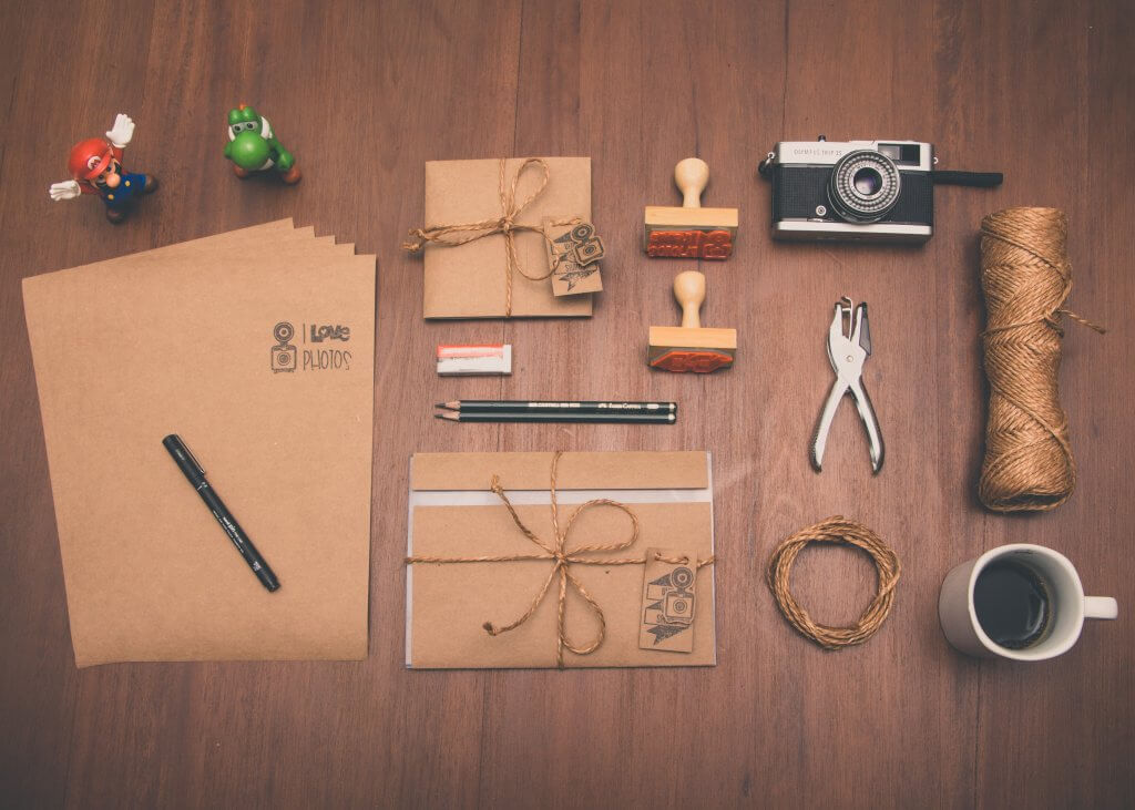 Wooden table with brown stationary items sprawled on it
