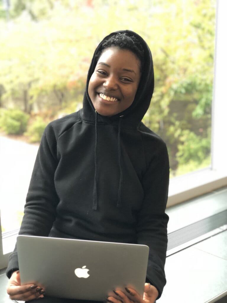 Humber student, Ashante Ford, posing with a MacBook.