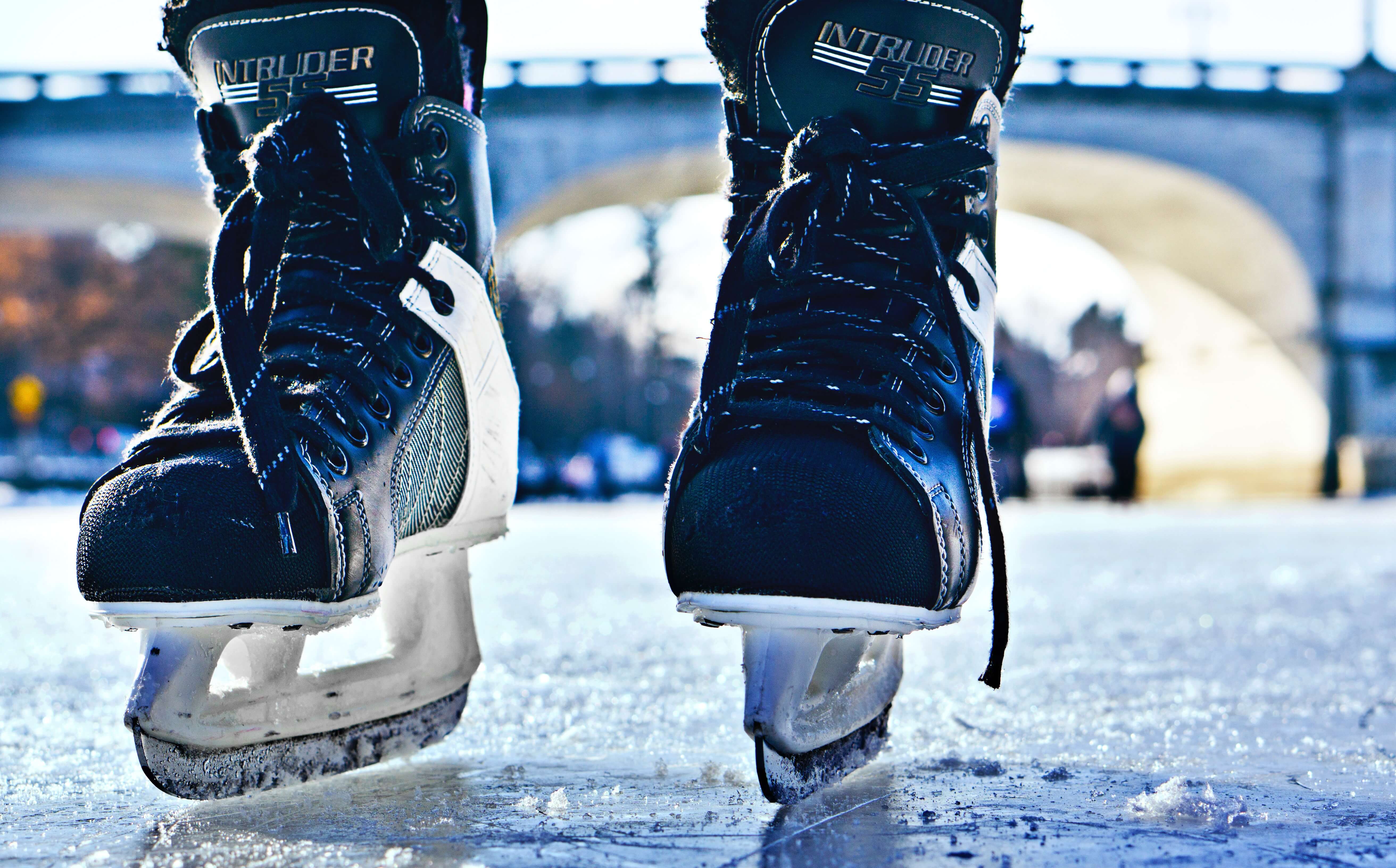 Pair of ice skates standing on ice.