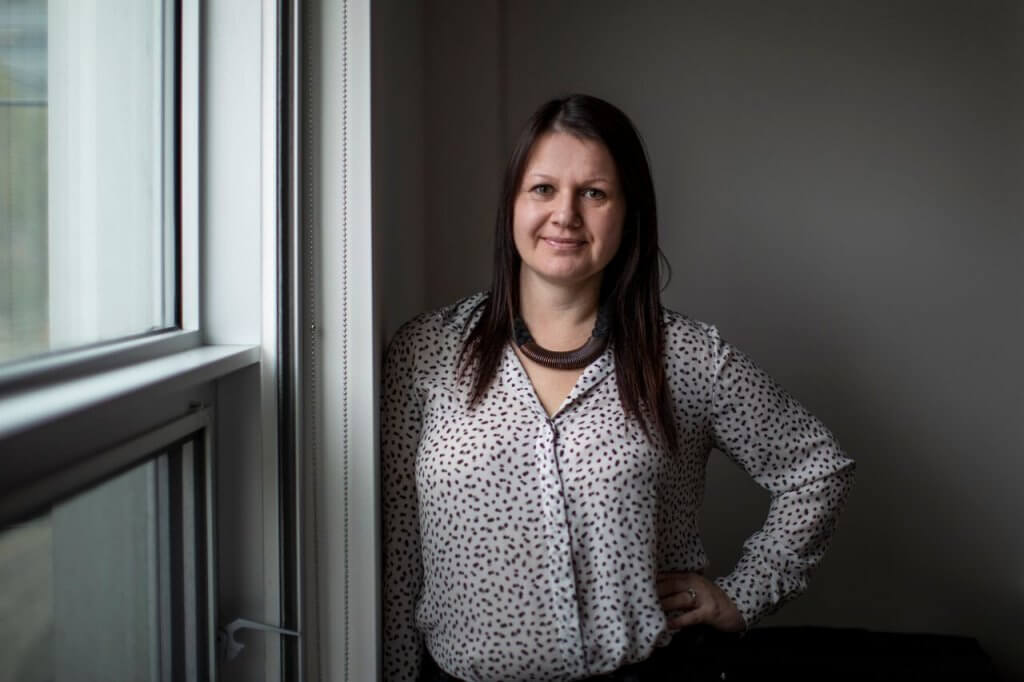 Larysa Woloszansky standing by a window in her office at University of Toronto.