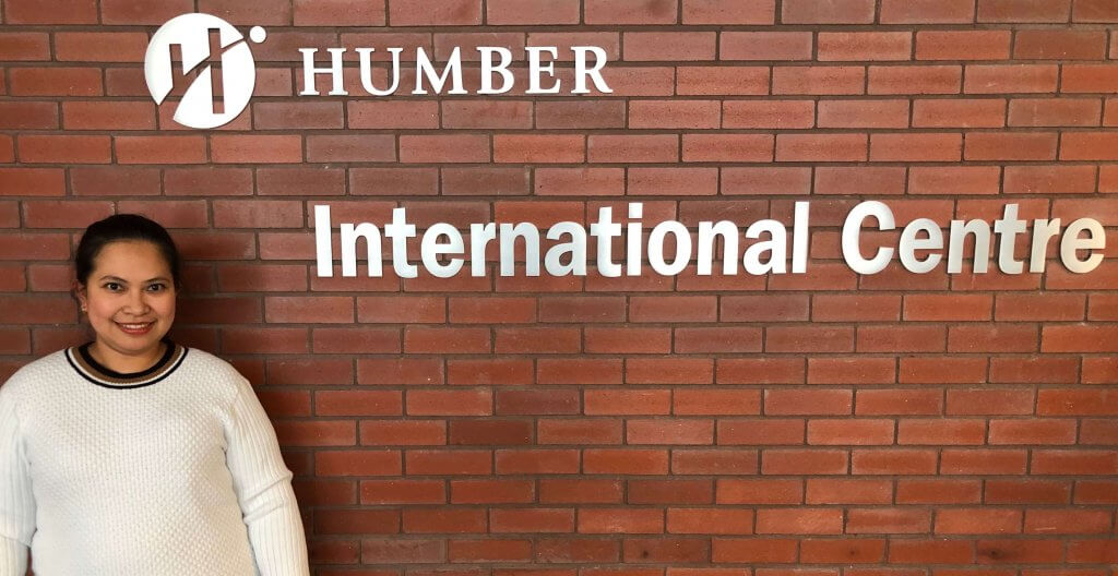 Emmalyn Giray standing inside the International Centre at Humber's Lakeshore Campus.