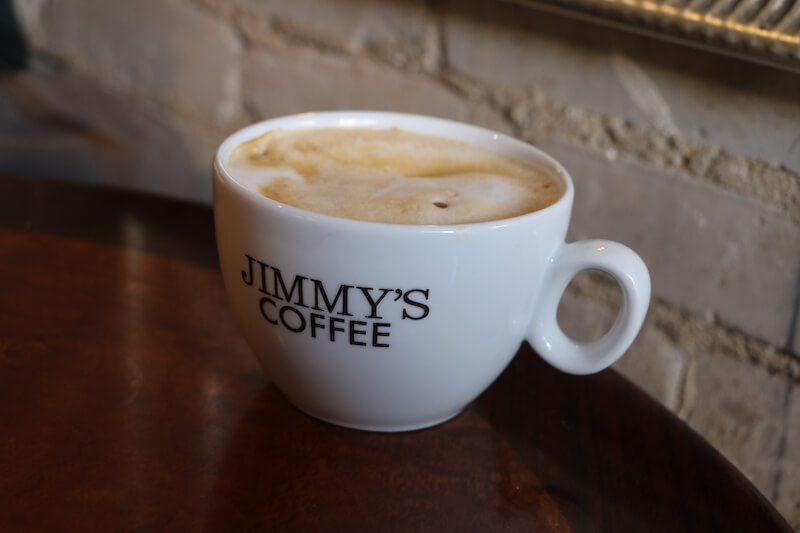 cappuccino in cup reading "Jimmy's Coffee"
