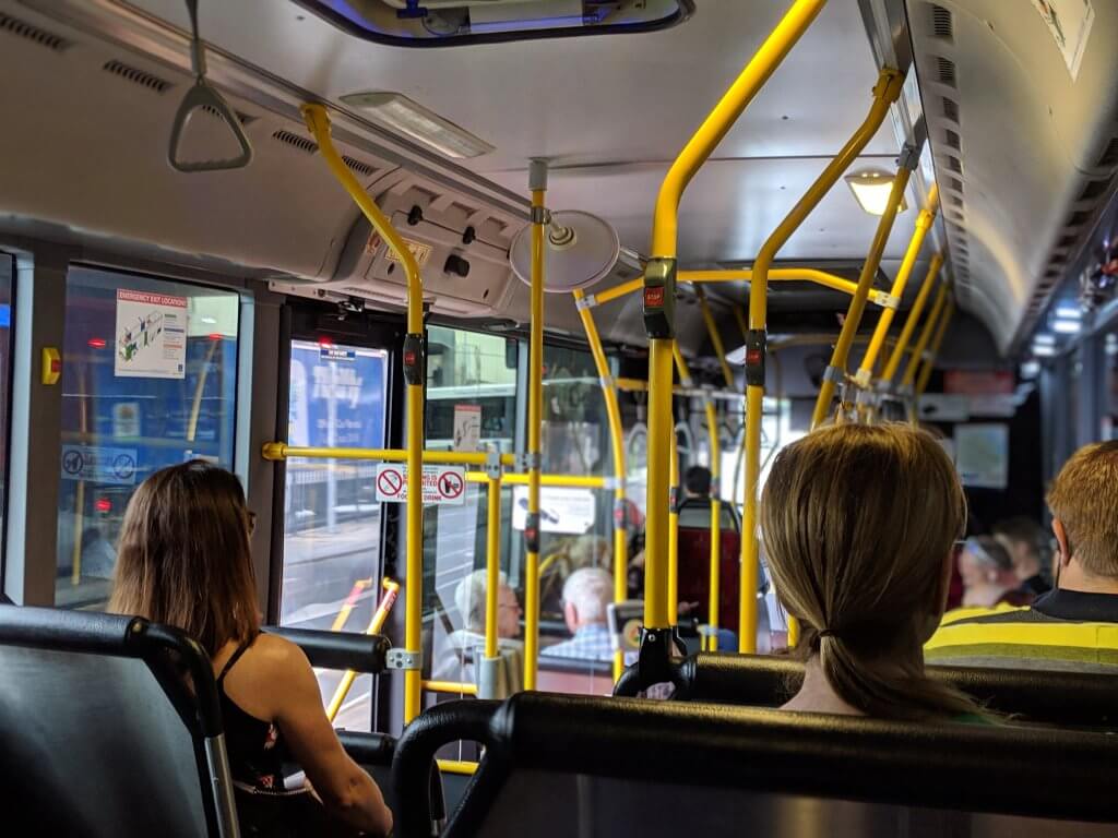 Passengers sitting inside of public bus.