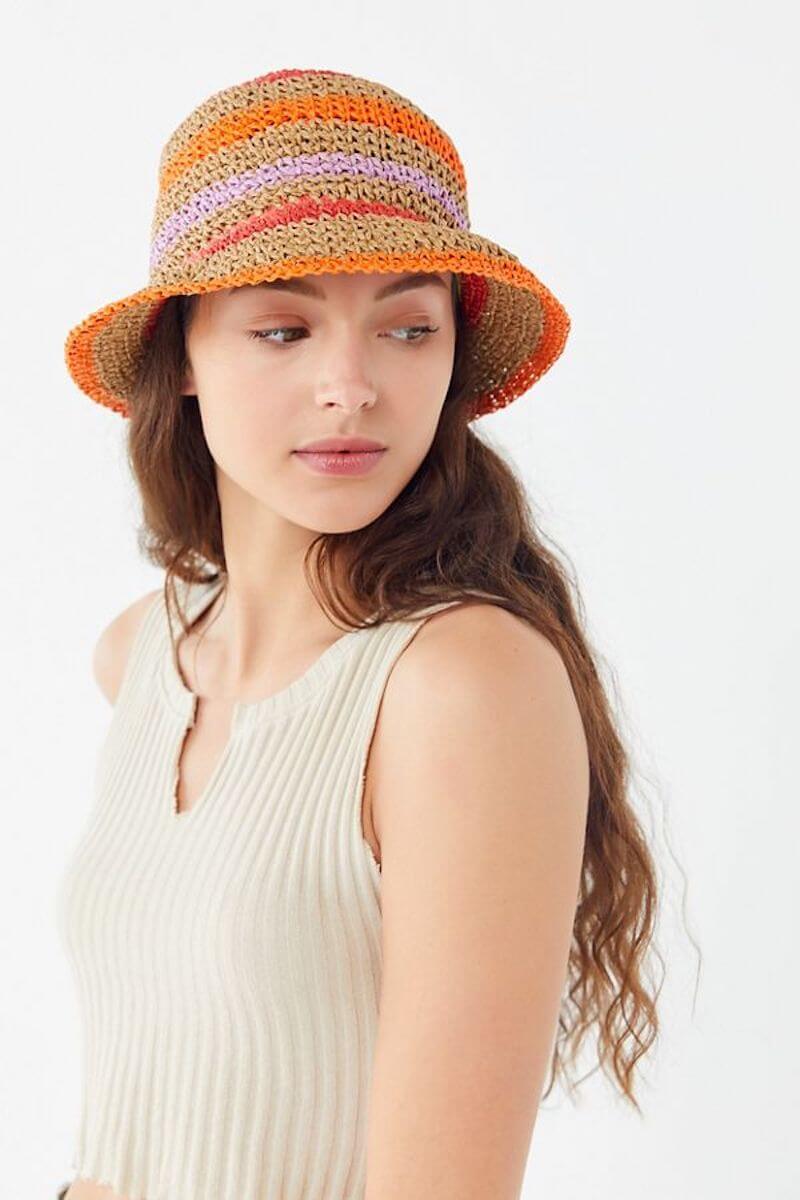 Woman wearing colourful, striped straw hat
