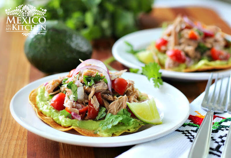 Mexican Tuna Tostadas with lime on side and avocado in background