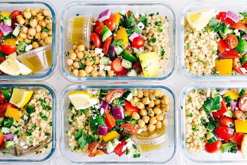 6 meal prepped bowls of chickpea couscous greek salad