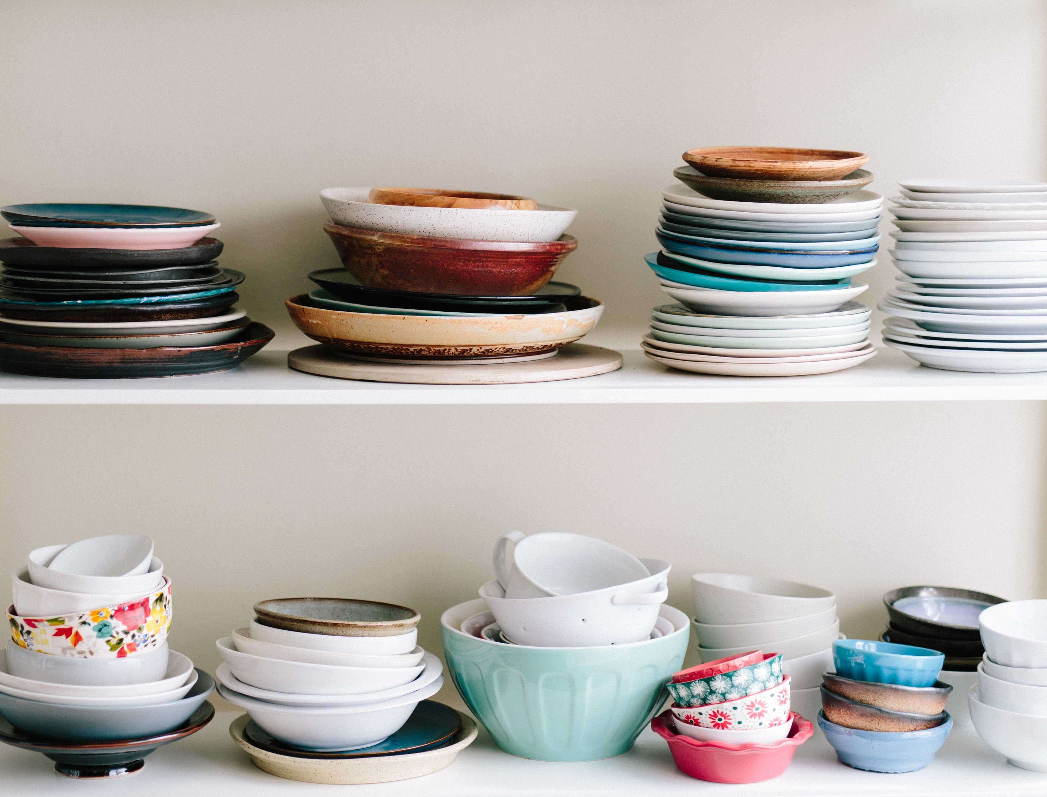 plates and bowls stacked on a shelf