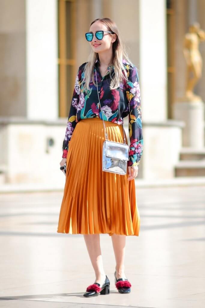 Woman on street wearing colourful outfit.