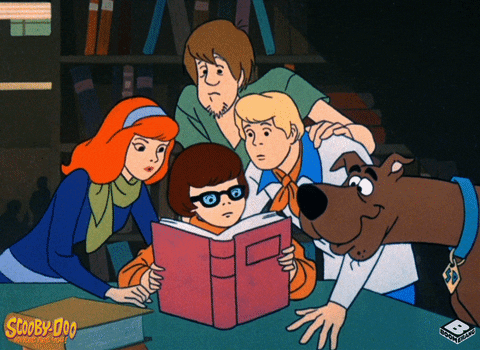 Scooby Doo characters reading a book.