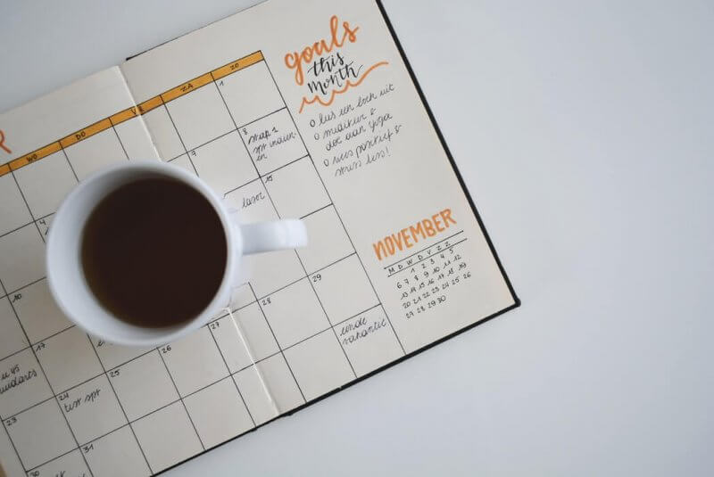 agenda with coffee cup on table