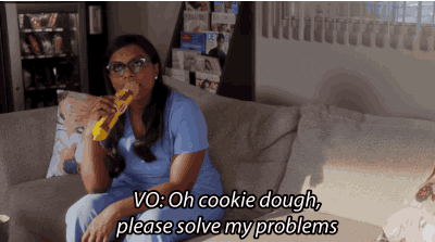 Mindy from The Mindy Project eating cooking dough, stating "Oh cookie dough, please solve my problems"