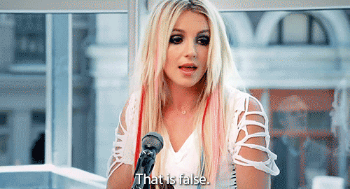Britney Spears leans into a microphone and says, "That is false."