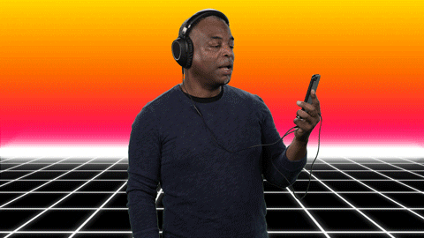 LeVar Burton wears headphones and looks at a smartphone screen while saying, "Amazing content!"