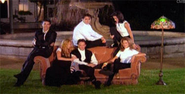 Courtney Cox, Jennifer Aniston, Lisa Kudrow, Mat LeBlanc, David Schwimmer and Matthew Perry converse and interact playfully on a couch in a park in the title sequence for, "Friends". 