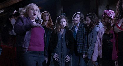Anna Kendrick as Beca Mitchell in, "Pitch Perfect" (2012) is surrounded by members of the Barden Bellas while making a funny face.