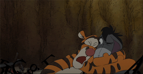 Tigger from, "Winnie the Pooh," gives an enthusiastic hug to his friend Eeyore.