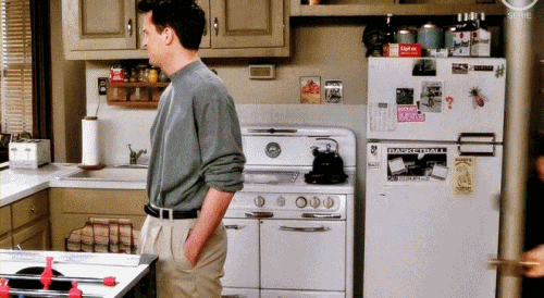 Scene from, "Friends" showing Joey hug Chandler from behind.