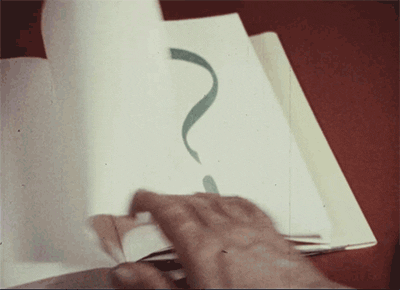 A person's hand flips through a notebook where every page boasts a large question mark.