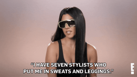 Kourtney Kardashian wearing sunglasses. Caption reads: I have seven stylists who put me in sweats and leggings.