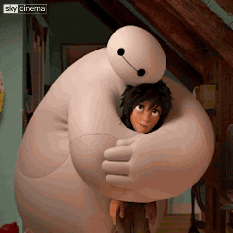 Scene from Disney's "Big Hero 6" (2014) depicting Baymax hugging Hiro Hamada and patting him on the head in an attempt to comfort him.