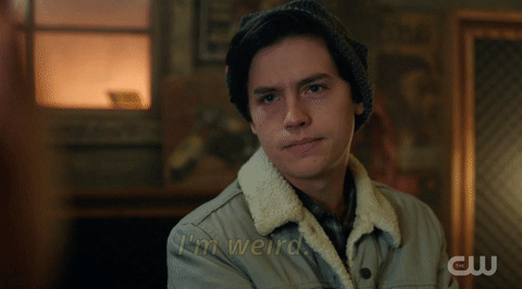 Clip from The CW's "Riverdale" (2017-) showing Jughead Jones (Cole Sprouse) wearing a light grey jacket with white fur trim. His arms are crossed and he says, "I'm weird. I'm a weirdo."