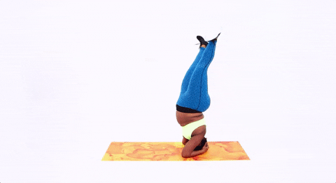 A woman does an elaborate yoga pose.