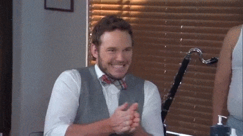 Actor Chris Pratt smiles and rubs his hands together with excitement.