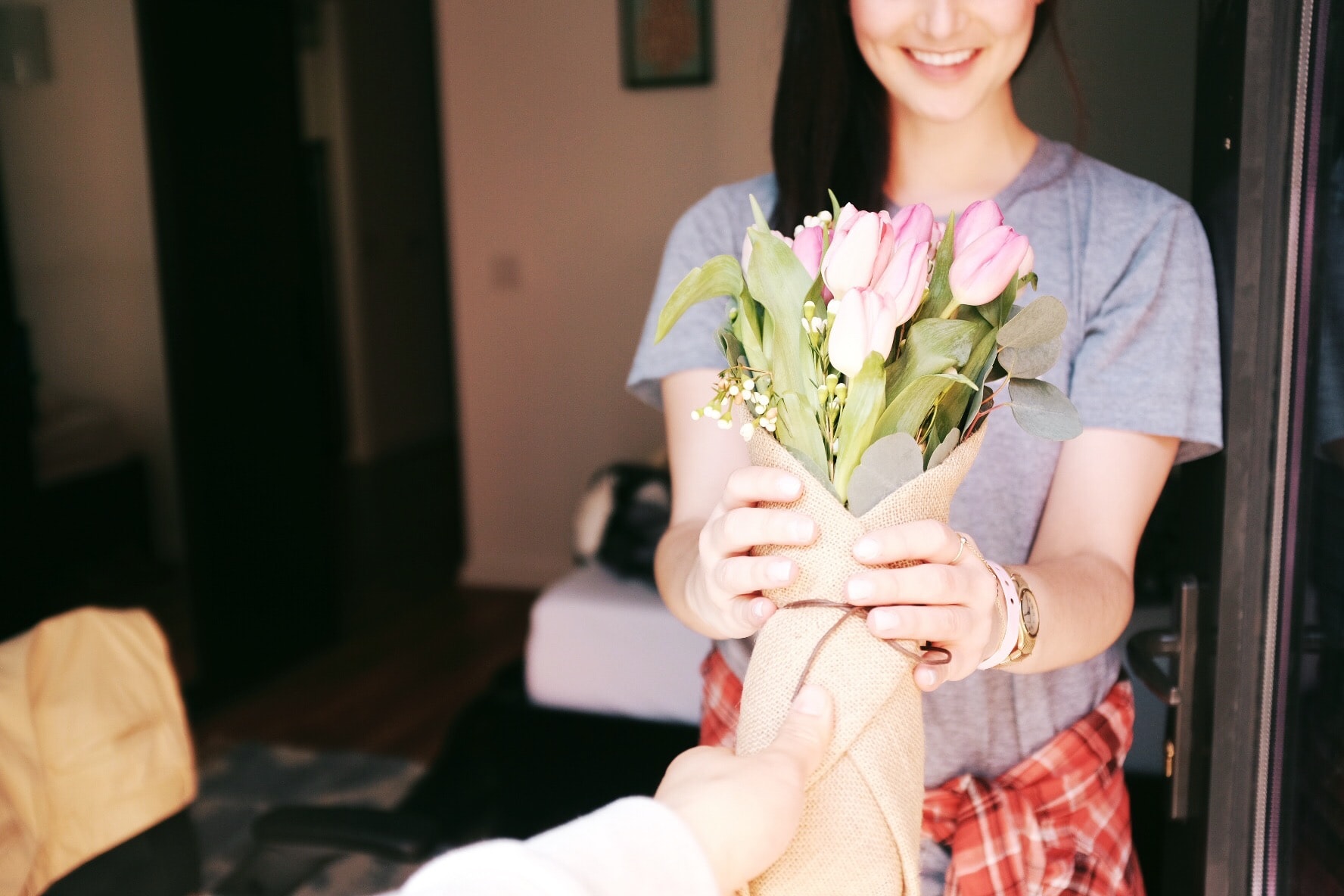 A woman accepts a bouquet of flowers.