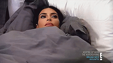 Kim Kardashian laying in bed annoyed