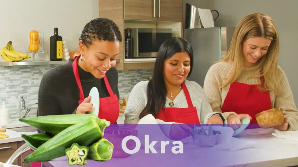three women looking into dishes with secret ingredient okra