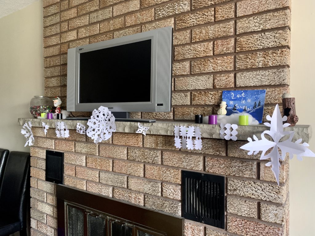 a television on a fireplace mantel