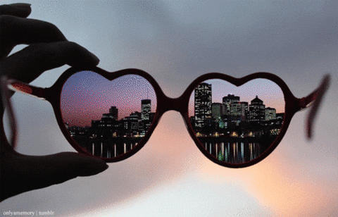 Heart-shaped glasses showing different landscapes.