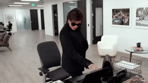 Kris Jenner closes a laptop.