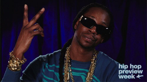 2 Chainz throws up a peace sign.