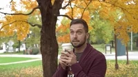 Man sipping pumpkin spice latte