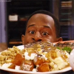 Man hungrily looking at a plate full of food.