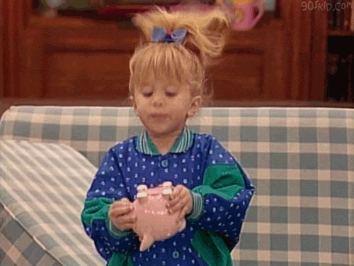 Michelle Tanner from "Full House" shaking a piggy bank. 