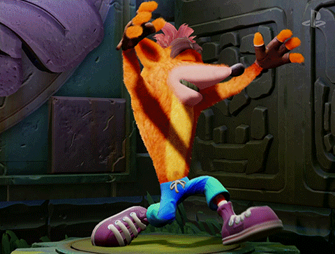 Crash Bandicoot kneels as the words "Ta da" appear at his sides.