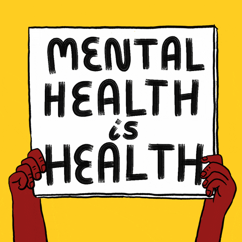 Hands holding up a sign that states "Mental Health is Health".