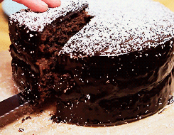 Cutting a chocolate cake. 
