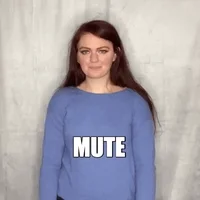 Woman lifts a remote and says "mute."